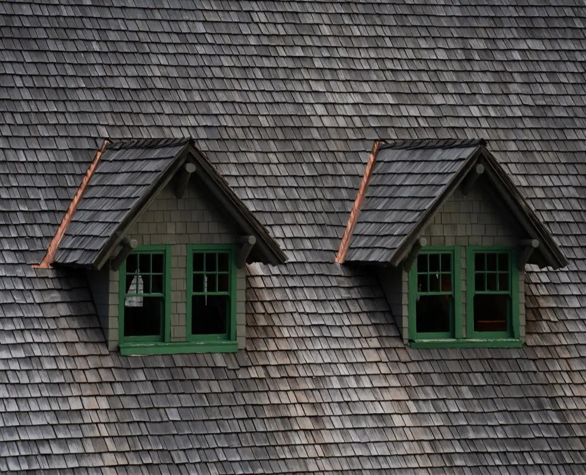 Dormers on a shingle roof in Grand Forks, ND, where step flashing and kickout flashing carry water past the walls
